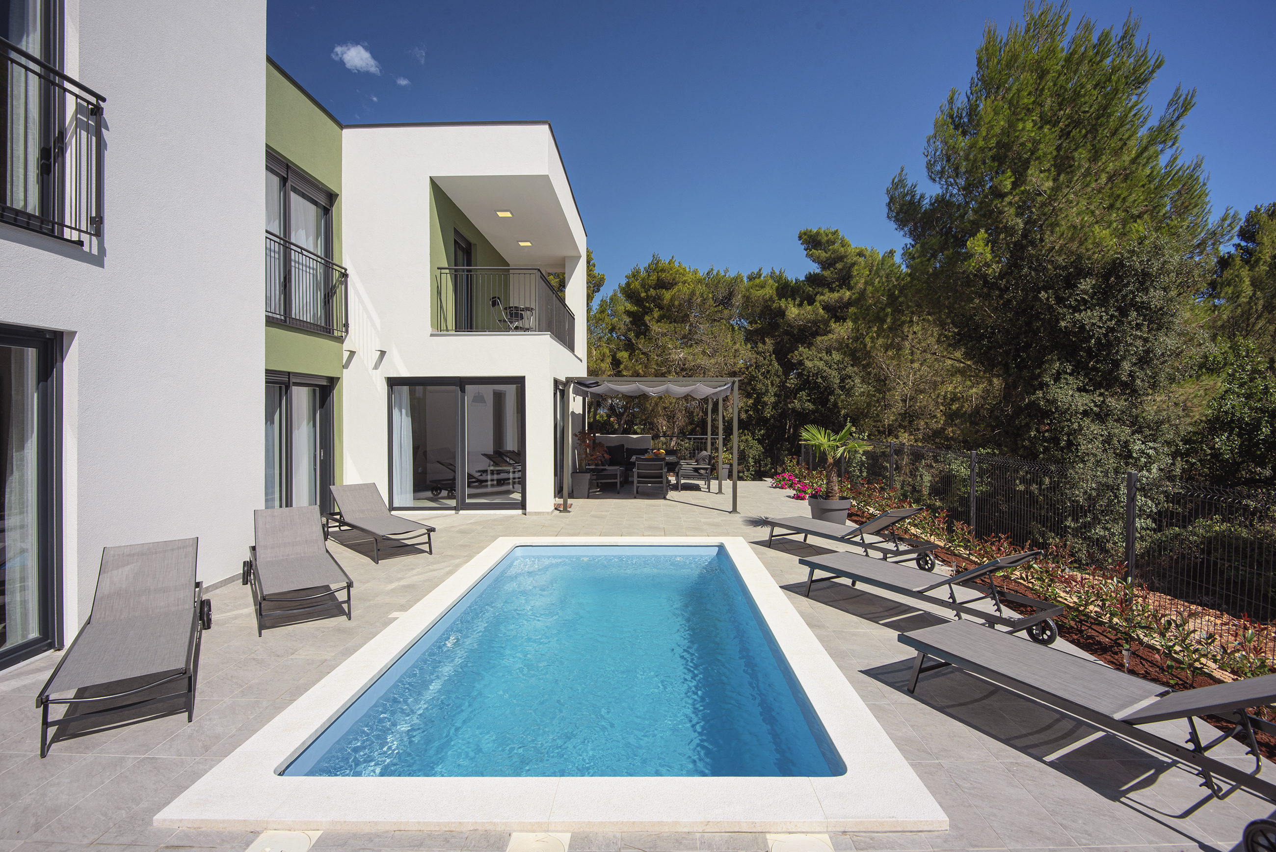 Modern villa surrounded by greenery with private pool