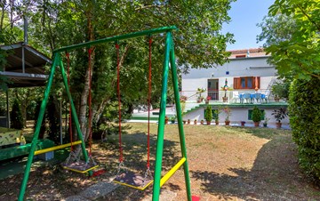Holiday house with terrace, BBQ and playground for children