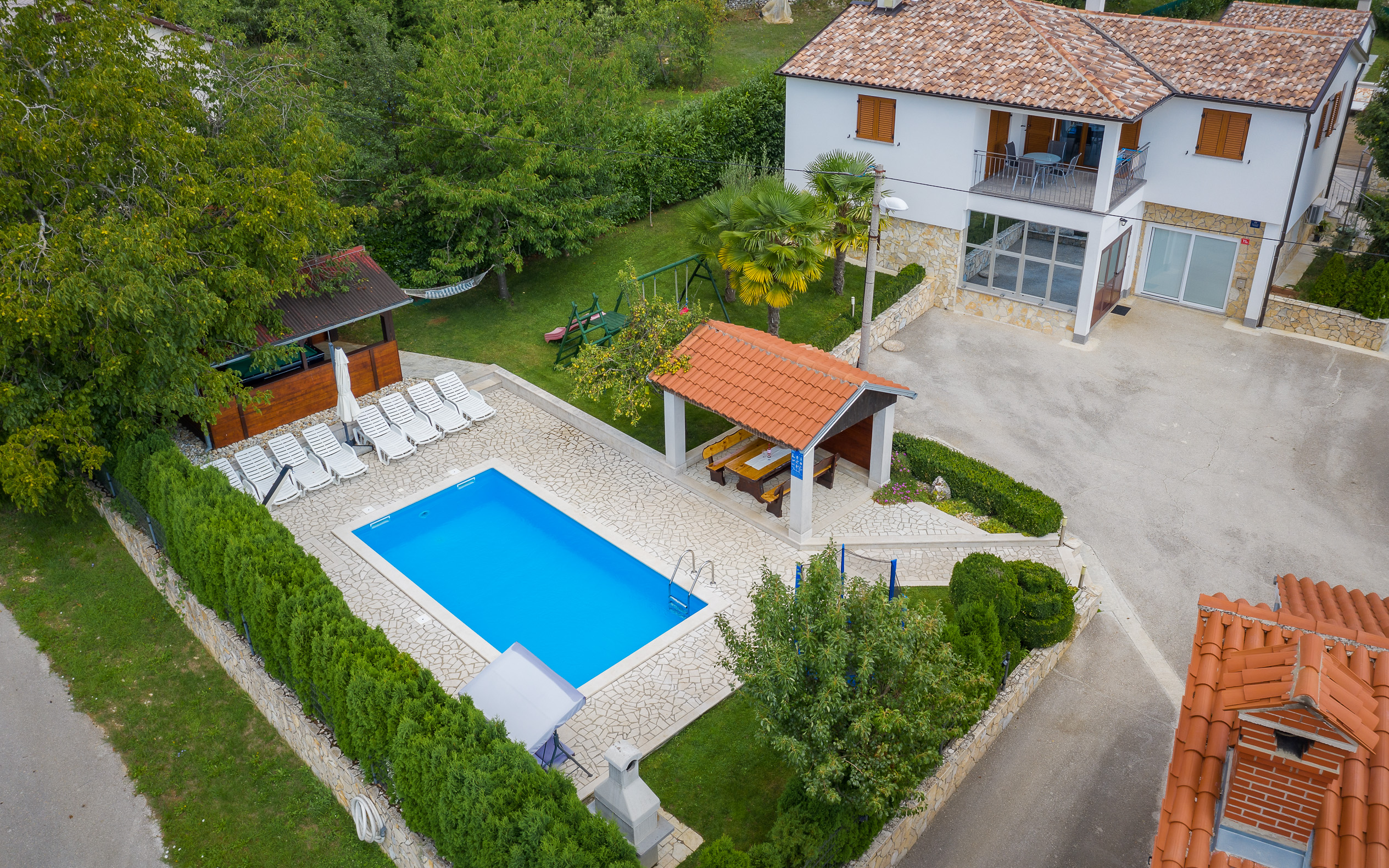 Villa with swimming pool, children playground and outside kitchen