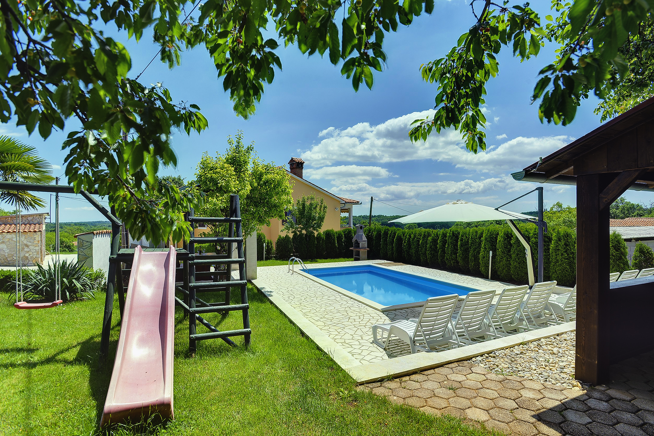 Villa with swimming pool, children playground and outside kitchen