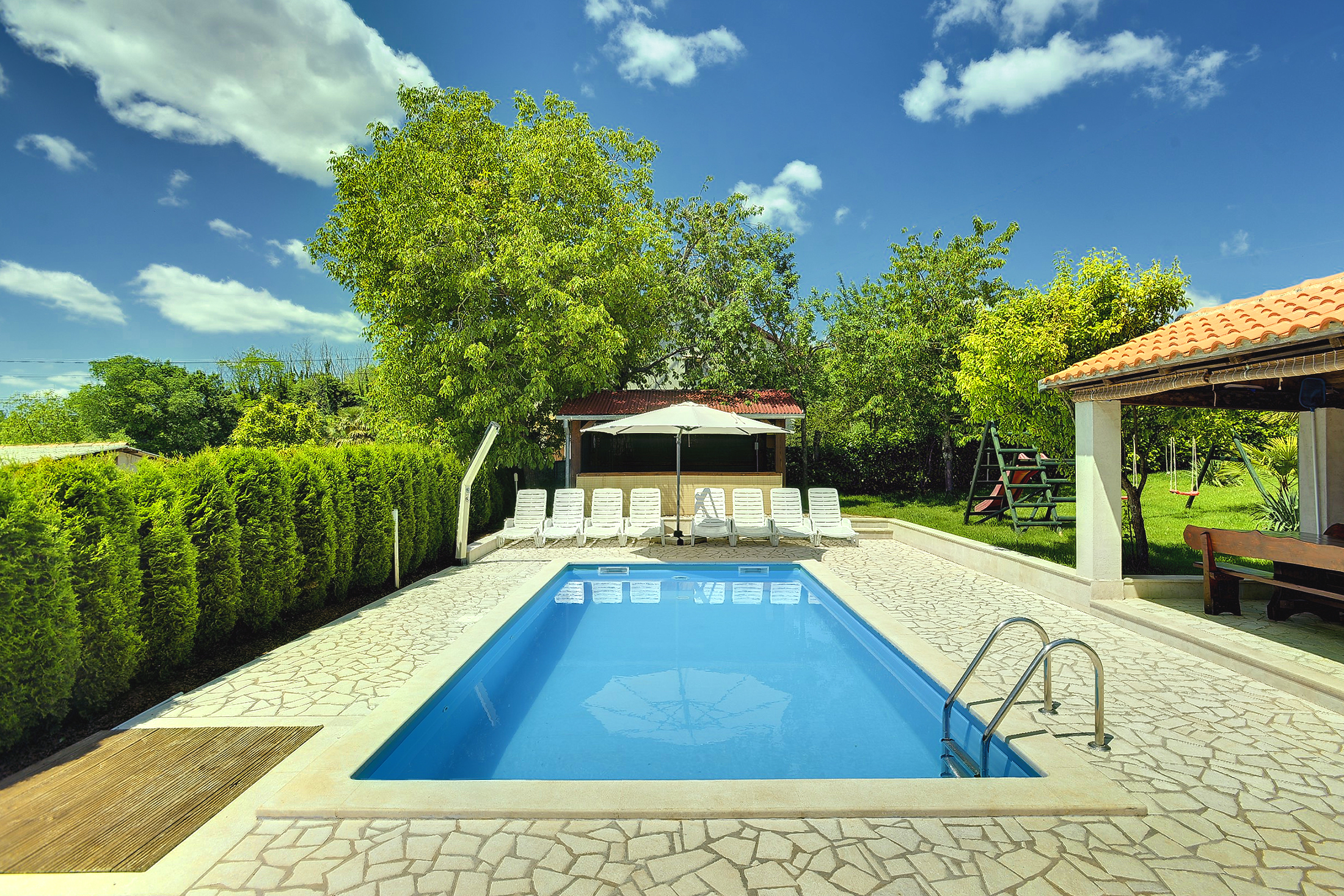 Villa with swimming pool, children playground and outside kitchen